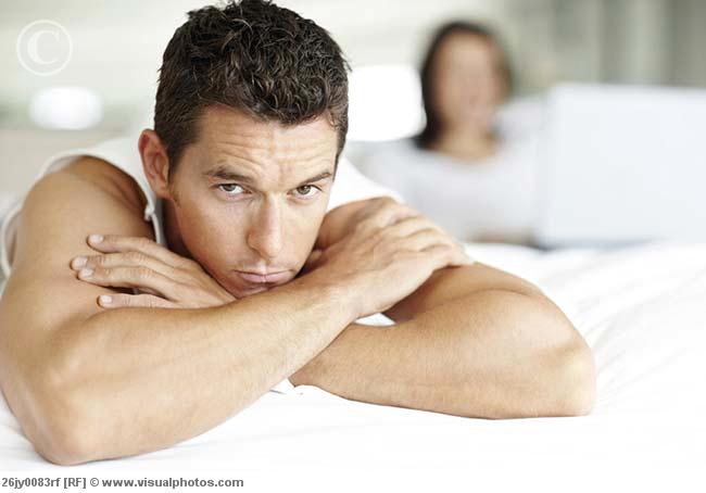 Bored man in bed with woman using laptop | Psychopathyawareness's Blog